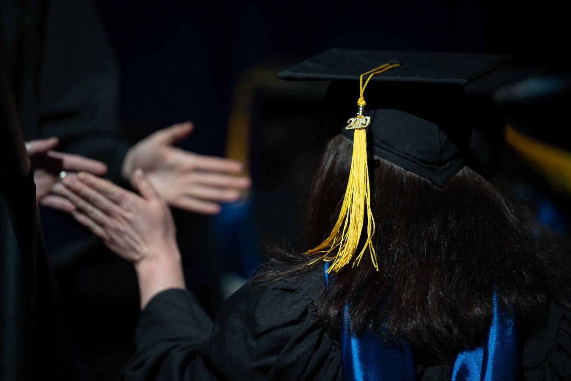 Graduating student gives high-fives